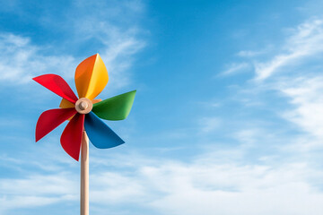 Colorful pinwheel spins joyfully in a gentle breeze under a clear sky