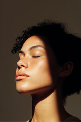 Close-up portrait of a young person with closed eyes in soft directional light