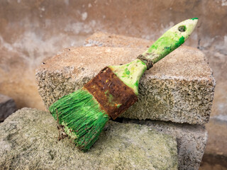 used brush with green paint that has dried because it was not cleaned