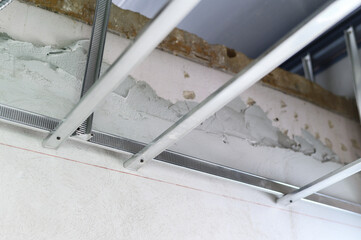 Witness crucial stage of interior renovation with installation of aluminum framing providing...