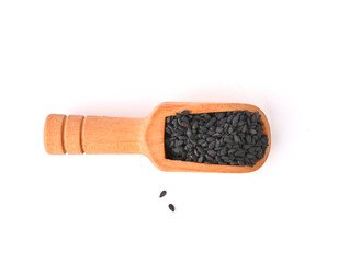 a wooden scoop with Organic black Sesame seeds (Sesamum indicum) or Til. Isolated on a white...
