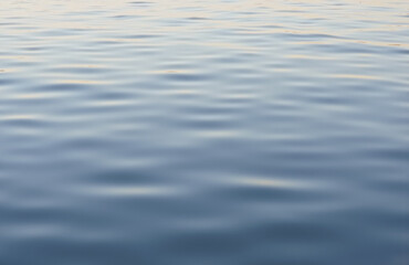 Calm water surface with soft blue-gray reflections