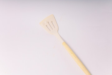 Kitchen White spatula on isolated white background. White silicone spatula with wooden handle....