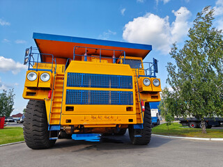 Belaz trucks in Minsk, Belarus. Heavy-duty mining truck with large tires and bright yellow body...