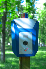 Panic alarm for call to police, emergency button in public park.