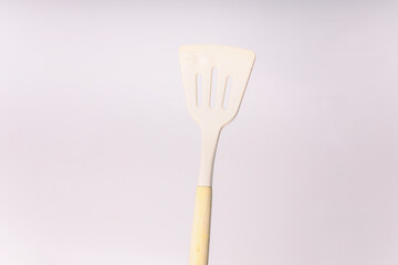 Kitchen White spatula on isolated white background. White silicone spatula with wooden handle....