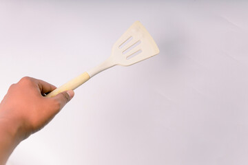 Kitchen White spatula on isolated white background. White silicone spatula with wooden handle....