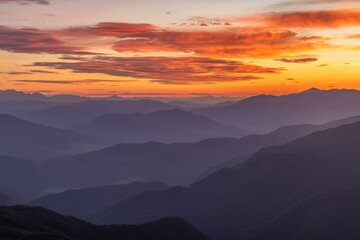 Fototapeta premium Panoramic Mountain View at Sunset Showcasing Layers of Peaks and Vibrant Skies
