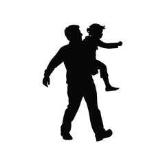 Silhouette of father giving his daughter a piggyback ride while walking