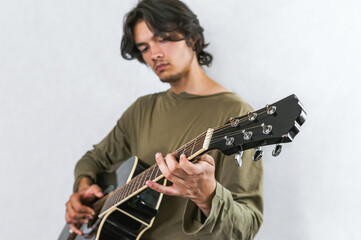 Focused Musician Playing Acoustic Guitar with Concentration