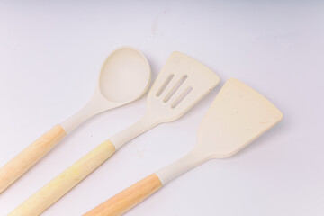 White Silicone cooking utensils set with wooden handle isolated on white background. Kitchen tool...
