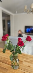 Red Roses in Vase on Wooden Table