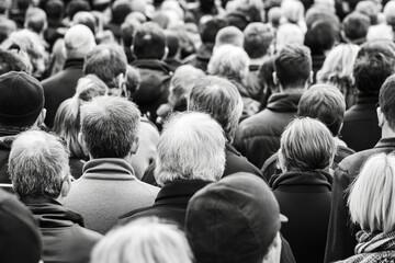 Crowd gathered in silence contrasts with the noise of daily life