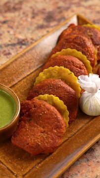 Mutton Galouti Kabab and Sheermal, plated in a beautiful plate with green mint Chutney