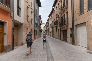Way of St. James. Two pilgrims on San Nicolas Street in Estella