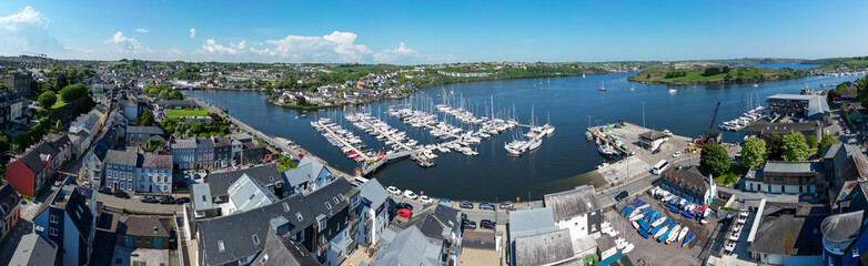 Kinsale, Ireland, May 20, 2025: Kinsale Bay and Harbor looking at the coastline where boats sail from a UAV Drone with Sailboats in the Harbor