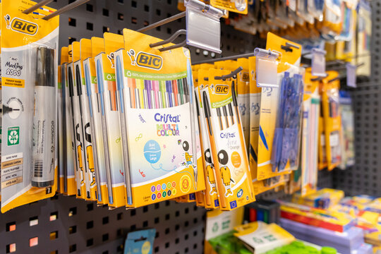 Poznan, Poland - June 30, 2025: BIC writing instruments, including diverse pens and markers, neatly displayed on a retail shelf, essential for back to school