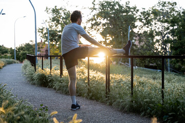 Adult man doing physical exercise and stretching outdoors
