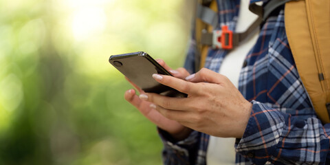 Digital Connection: Young Woman Using Smartphone While Hiking