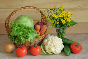 Fresh vegetables and a bouquet of meadow buttercups in the kitchen