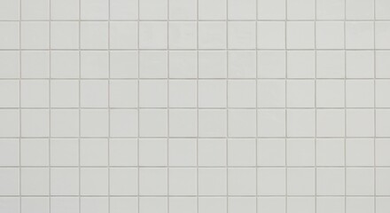Wall covered in small uniform lightcolored square ceramic tiles with thin light grey grout lines