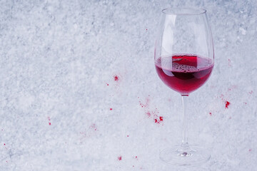 Elegant wine glass with red wine pour creating a chaotic splash