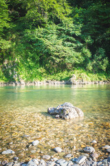 A small waterfall among the rocks on the mountain river in Georgia. Panoramic picture.