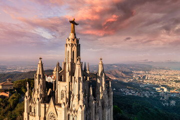 An aerial view capturing the iconic Sagrat Cor church atop Mount Tibidabo, with its grand...