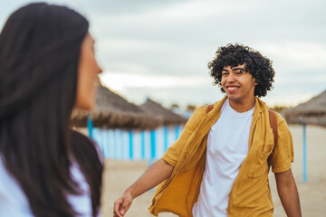Smiling Friends Meeting on a Beach During a Sunny Day Vacation