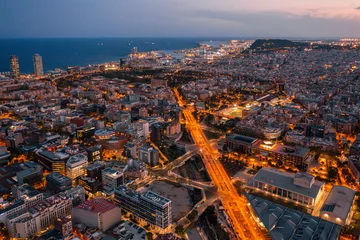 Fotobehang Barcelona  Barcelona Urban Grid: Illuminated Streets and Residential Blocks at Dusk  An aerial view of Barcelona's Eixample district at dusk, showcasing its iconic grid pattern of illuminated   © aleonovs