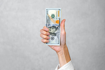 Hand Holding Stack of US Dollars: High Investment Profit