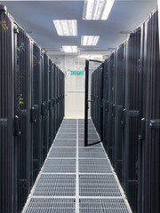 Modern IT server room with rows of black server racks in a high-tech data center environment,...