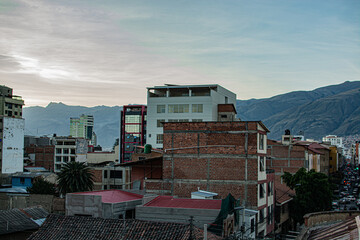 Fototapeta premium Sunset Over Downtown Cochabamba with Mountain Background