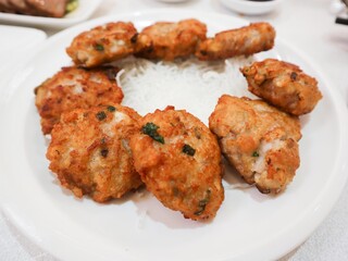 close up of Chinese dish pan fried lotus root minced cake presented in a round plate