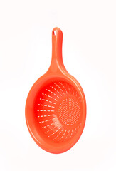 Bright orange plastic colander with handle isolated on white background, kitchen utensil for...