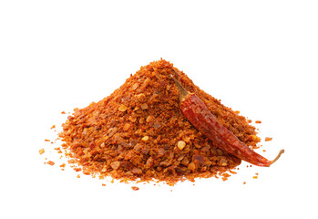 Heap of crushed red chili flakes with a dried whole chili pepper on a white background visible clearly