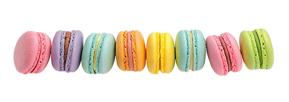Colorful macarons aligned in a row showcasing a variety of flavors and vibrant pastel colors.