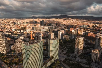 Selbstklebende Fototapeten Cappuccino An aerial view of Barcelona's expansive coastline, featuring a wide sandy beach, the urban sprawl, and mountains under a dynamic sky  © aleonovs