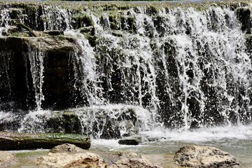 A close view of the water over the rocks.