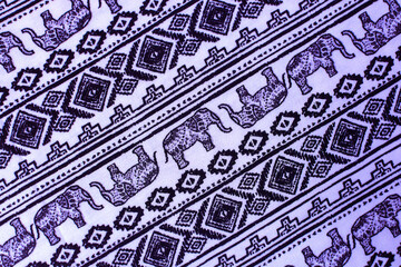 lilac fabric with elephants on it. geometric background with animals