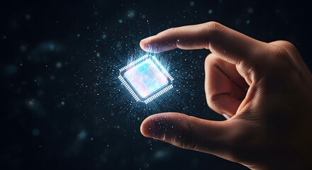 Hand holding a glowing, futuristic computer chip with digital particles floating around it against a dark background.