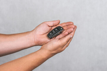 Car Security Solutions: Hands Holding Modern Vehicle Remote