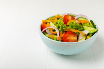 Cucumber salad on a wooden background.Homemade salad with fresh vegetables, cucumber, tomato, sweet...