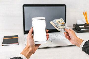 Smartphone and Cash in Hands Showing Online Payment or Mobile Banking Concept