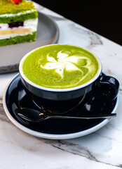Matcha Latte with Green Cake on Marble Table – Cozy Artisan Café Scene