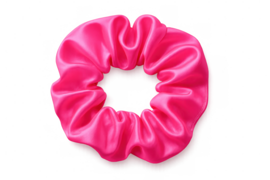 Delicate pink fabric hair scrunchie resting against transparent backdrop, highlighting textile texture and accessory design