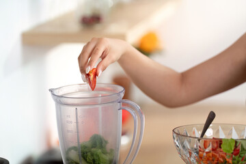 Healthy Lifestyle. Preparing fresh smoothie with vegetables in a blender.