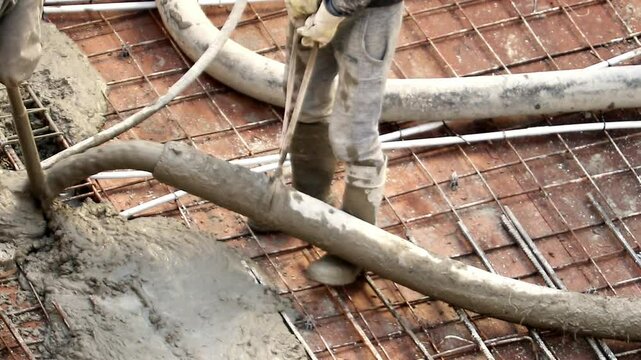 Construction workers pouring concrete on a building site