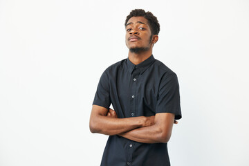 Confident black man posing with crossed arms, showcasing style and determination. His strong...