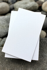 Blank White Card on Natural Pebbles Spa or Invitation Concept